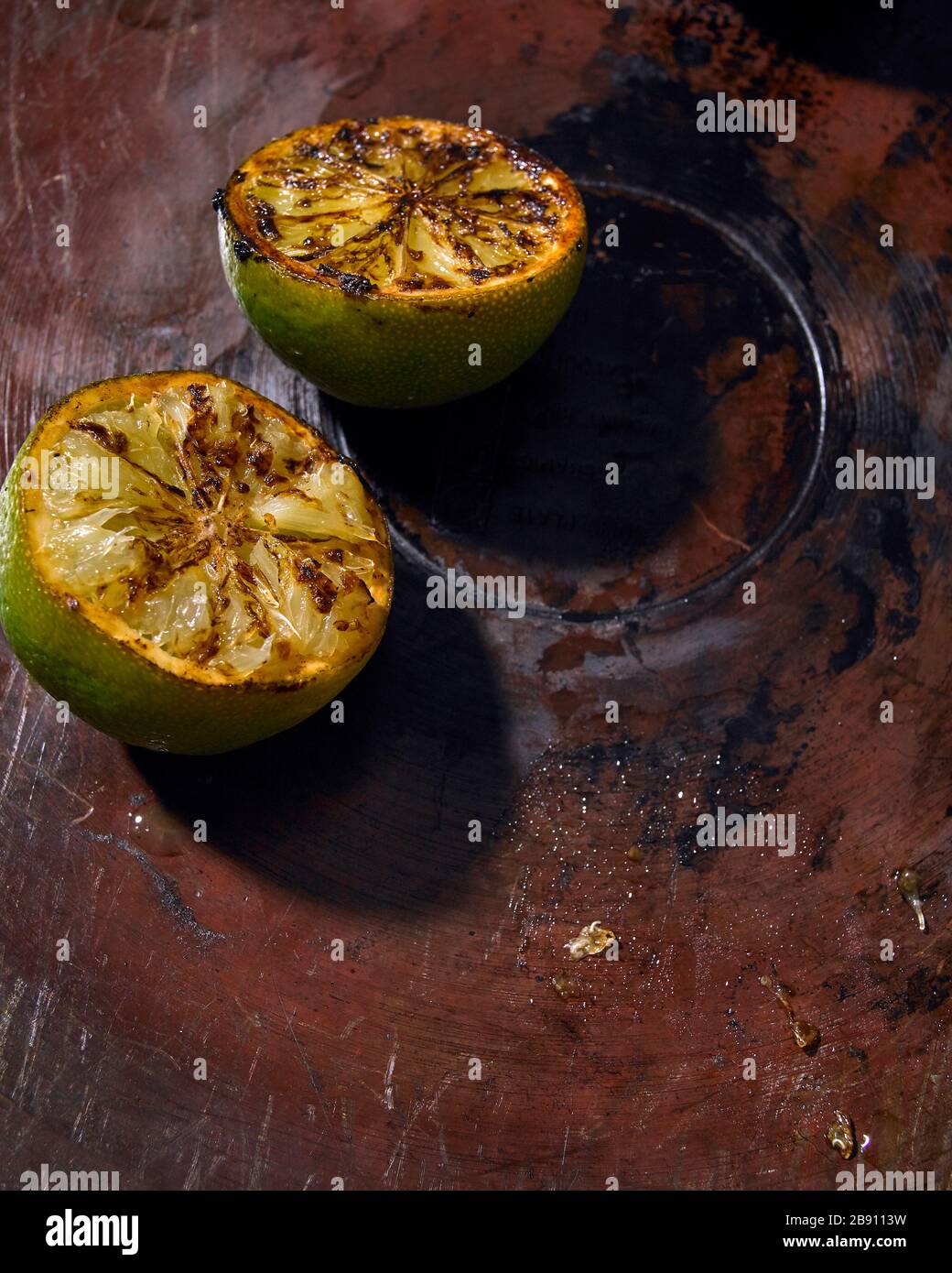 Caramelised limes on a copper pan Stock Photo