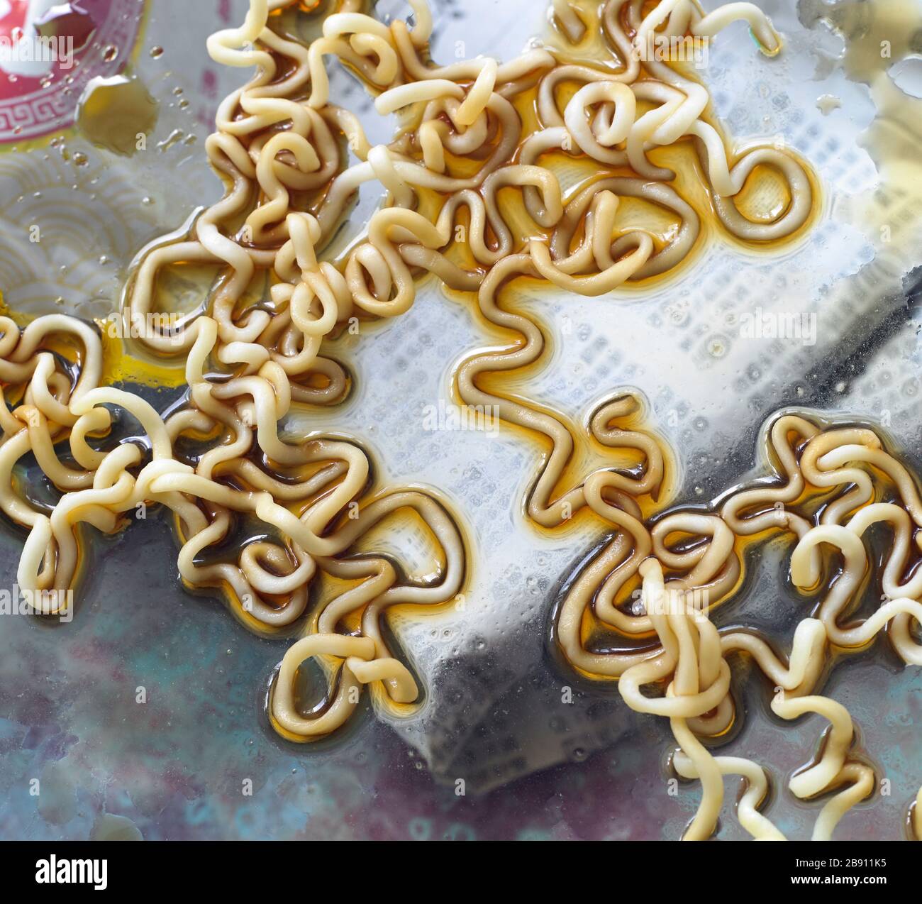 Noodles with soy sauce on a glass table Stock Photo