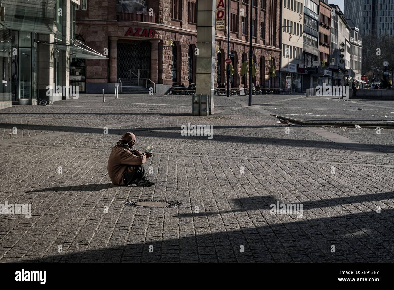 Beggars and homeless people in Dortmund in times of Corona crisis. Dortmund's city centre is almost deserted despite the weekly market. Only a few still do their shopping, some with face masks, like here on Hansaplatz. Stock Photo