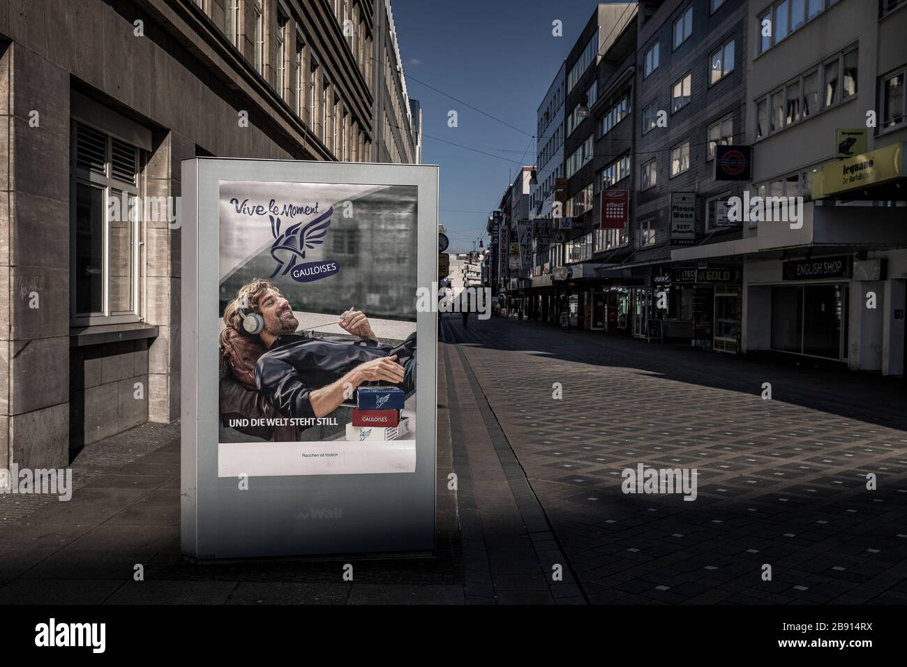 Advertising message in times of the Corona crisis. Dortmund's city centre is almost deserted despite the weekly market. Only a few people still do their shopping, some with face masks, like here in the pedestrian zone Stock Photo