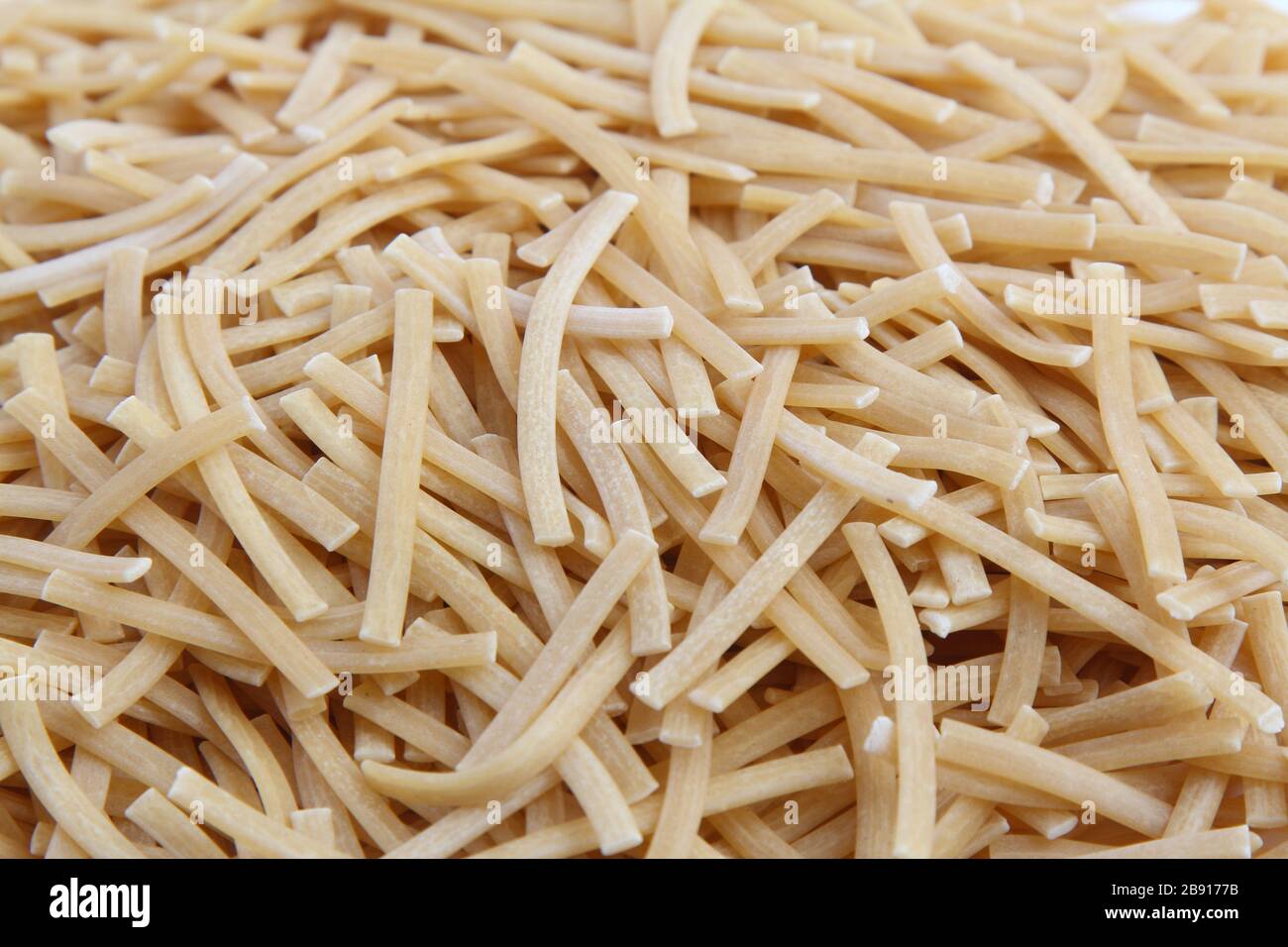 Dry uncooked vermicelli as a background texture. Closeup, top view