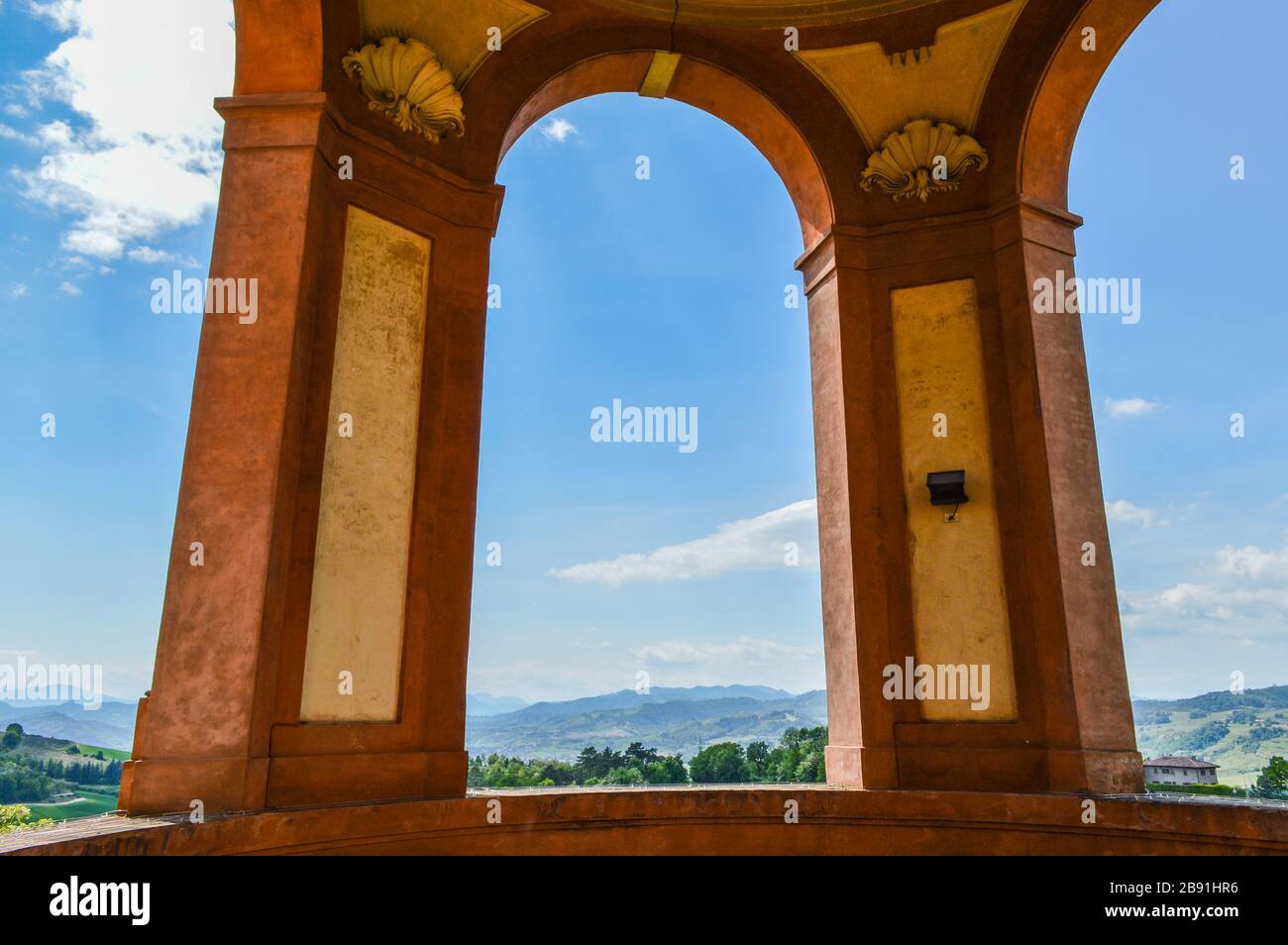 The hills around Bologna as seen through an arch of the 'Madonna di San Luca' sanctuary Stock Photo