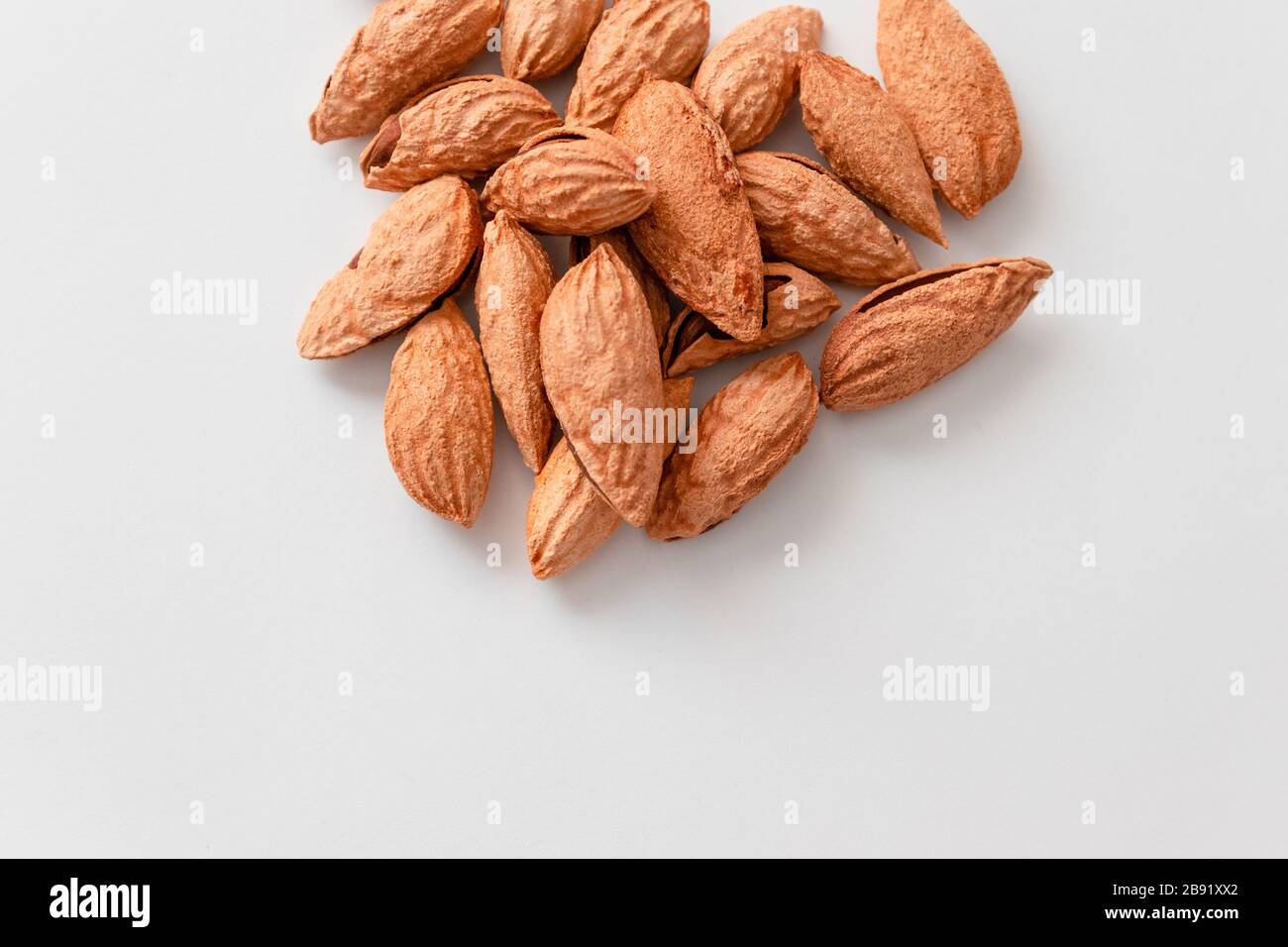 Inshell almonds heap on grey background. High calorie healthy food ...