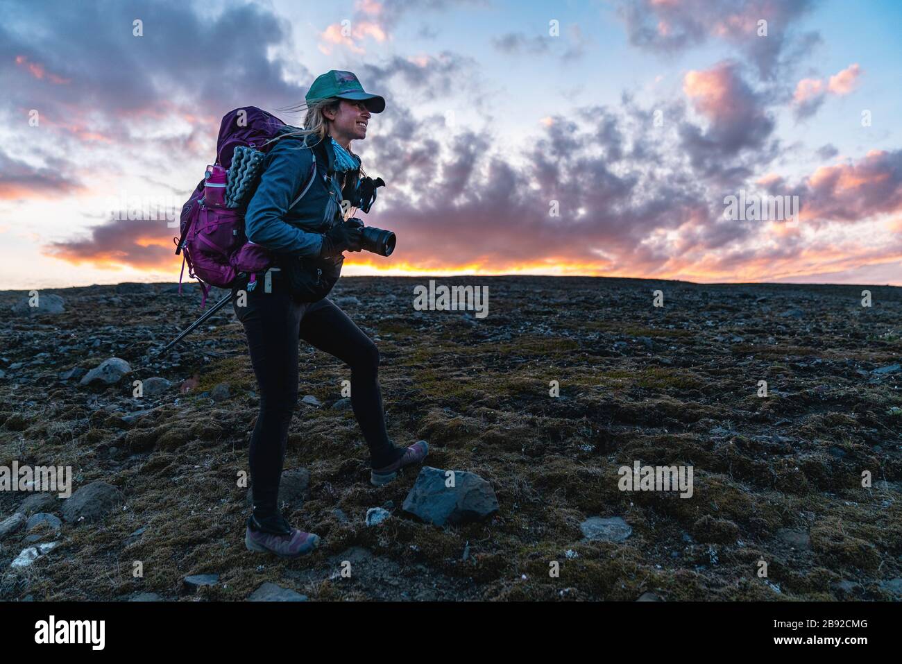 Backpacking Photographer Takes Photos At Sunset In Remote Highlands Stock Photo
