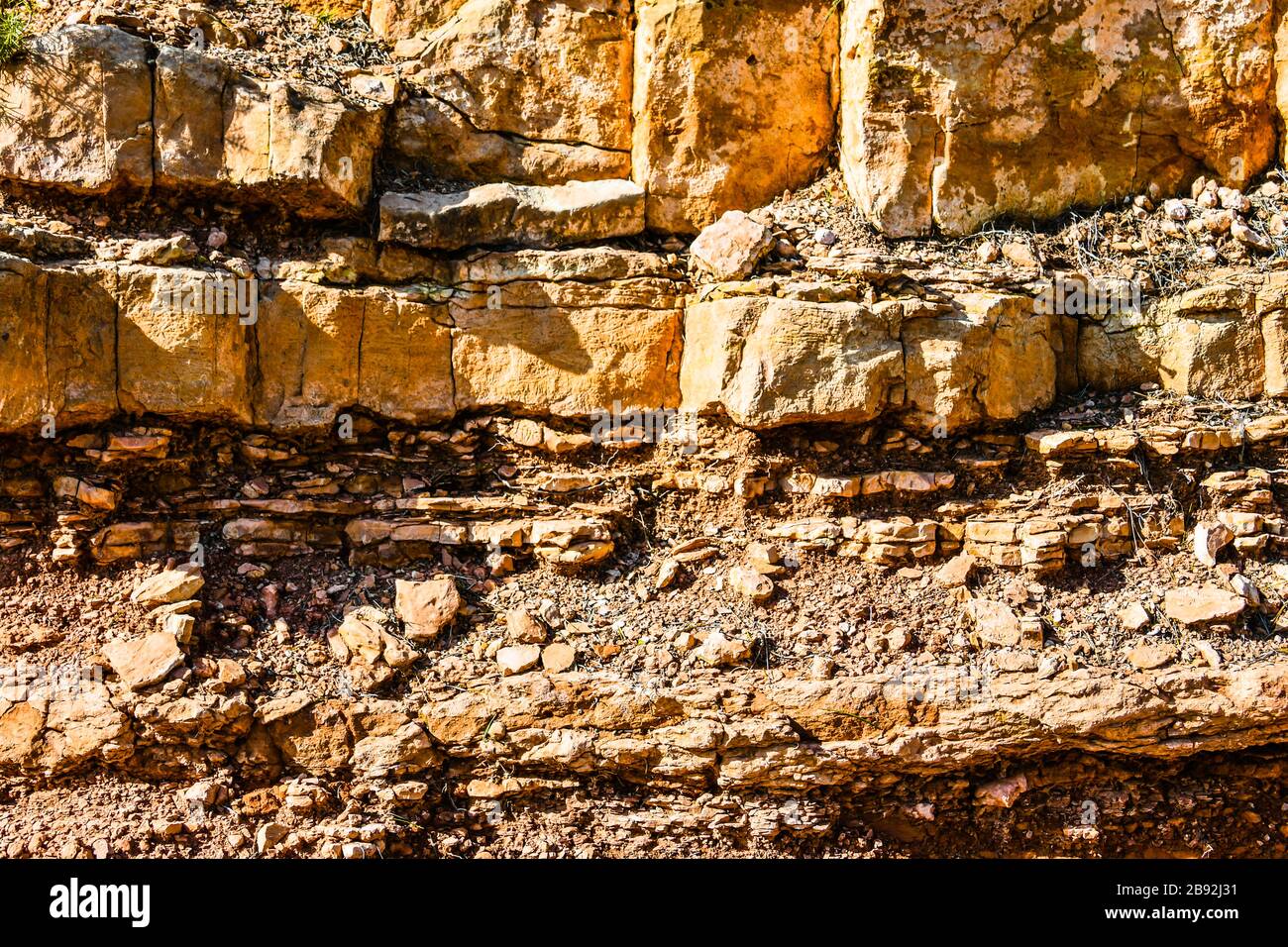 Rocky layered mountain wall background. Texture Stock Photo