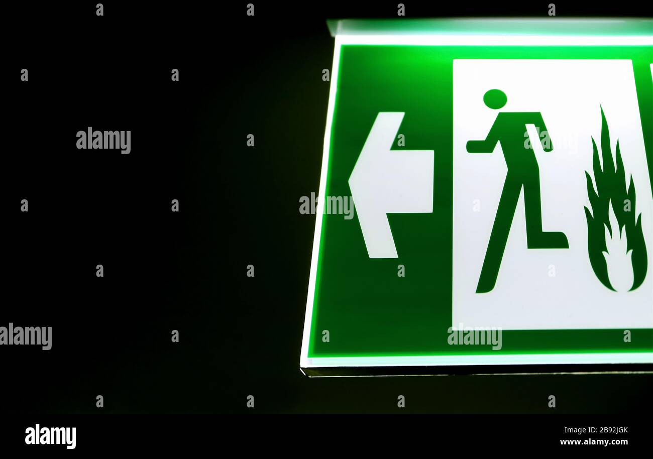 Emergency exit sign hanging on the wall with copy space Stock Photo Alamy