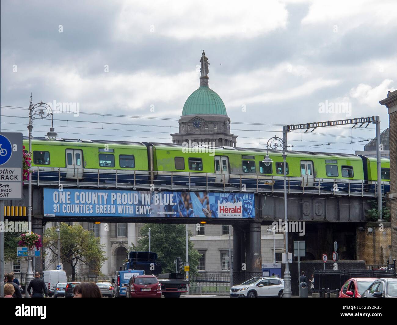 A DART train passes the dome on the Custom House in Dublin Ireland Stock Photo