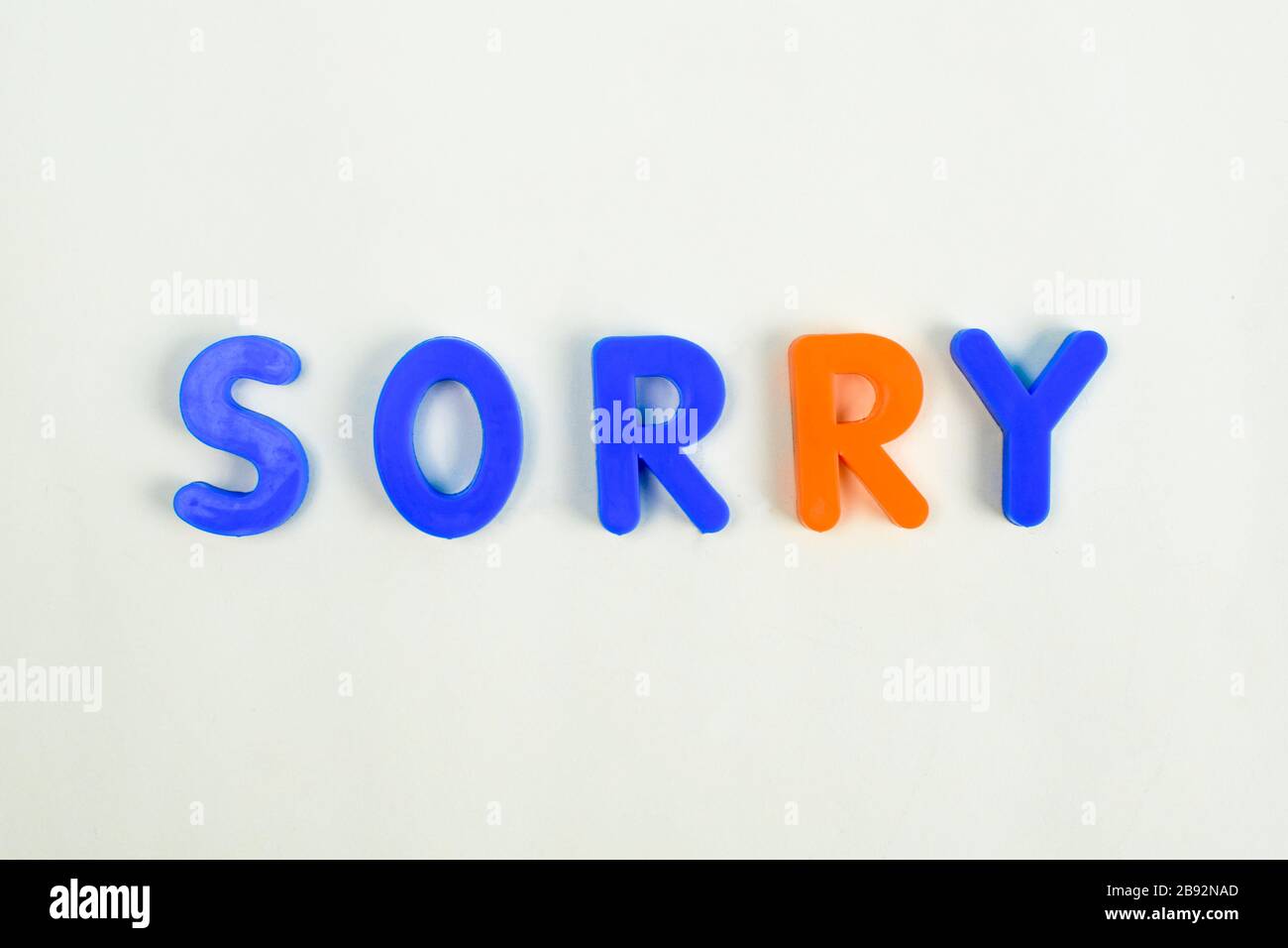 Sorry written in different colored letter blocks on an isolated white background Stock Photo