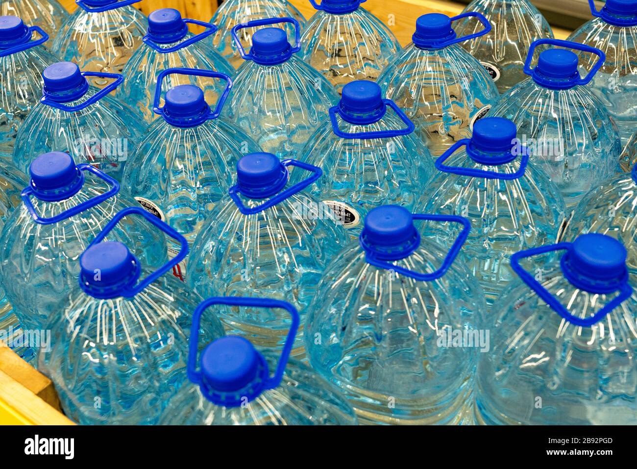 Drinking water bottles in a store. Batch of plastic bottles of water. Stock Photo