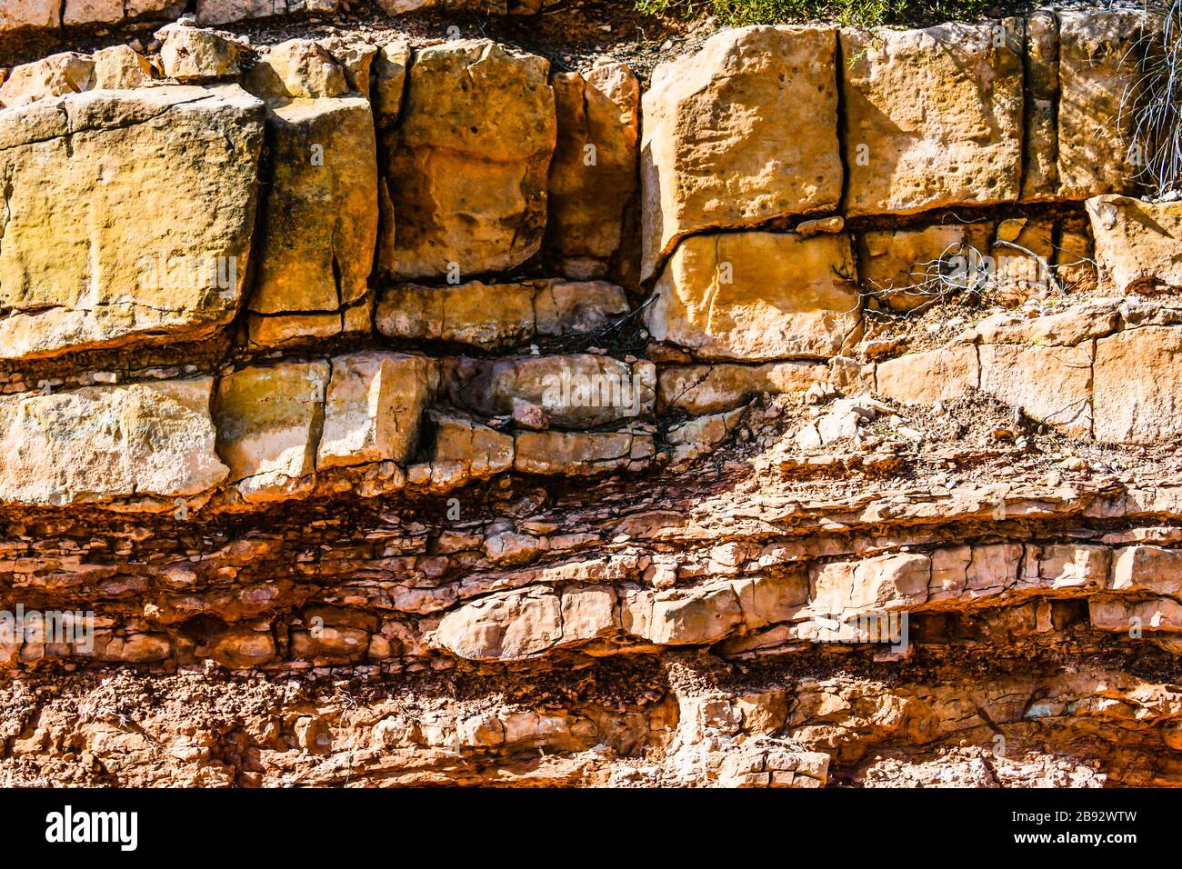 Rocky layered mountain wall background. Texture Stock Photo