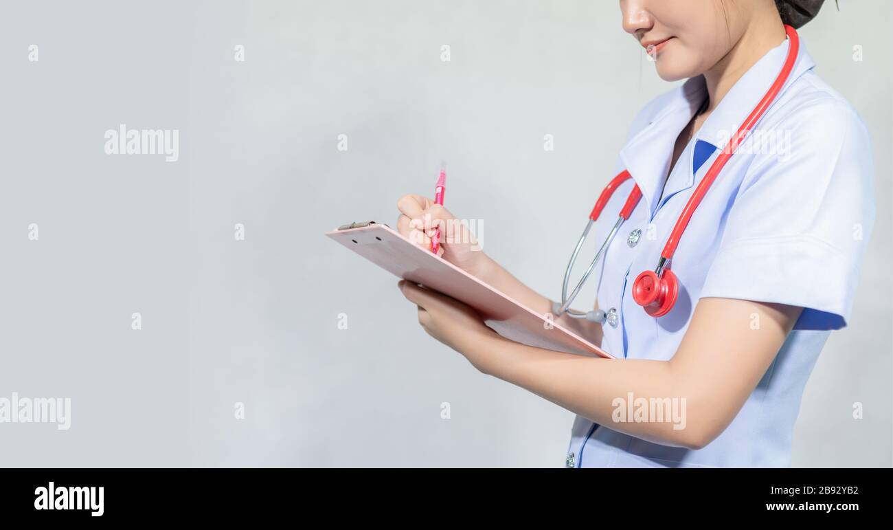 Female doctors are recording on the patient's history report Stock Photo