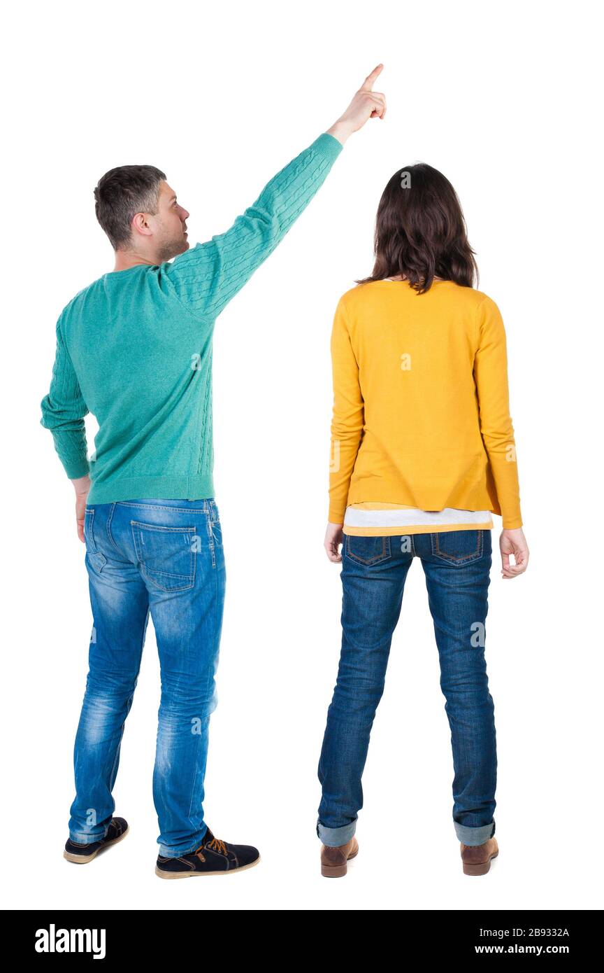 Back view of couple in sweater pointing. Rear view people collection ...
