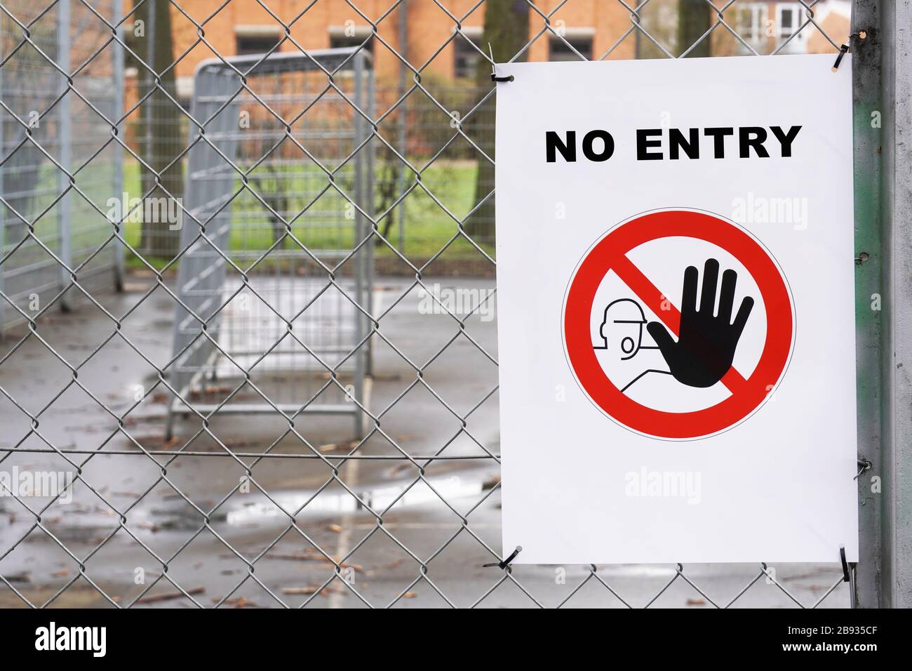 Closed sports football soccer ground with no entry sign on wire fence Stock Photo