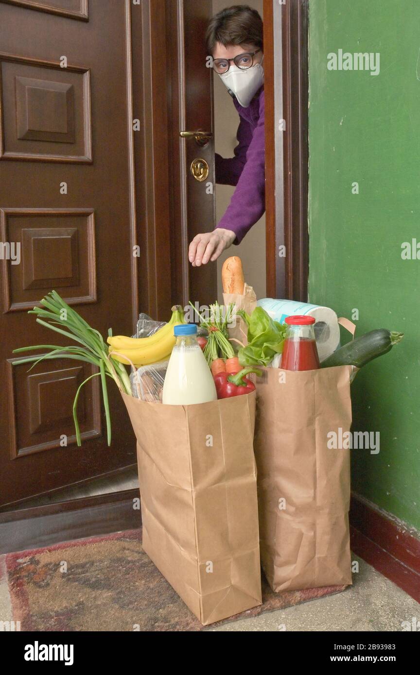 Delivering Food To A Self-isolate Woman or Quarantine At Home Stock Photo