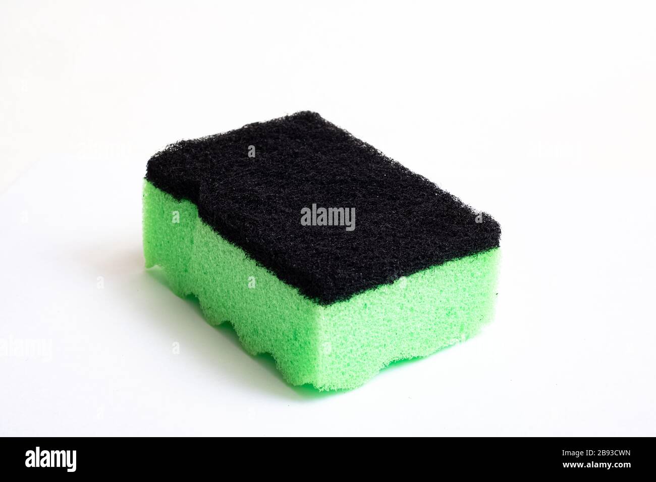 Green sponge for washing dishes on white background Stock Photo - Alamy