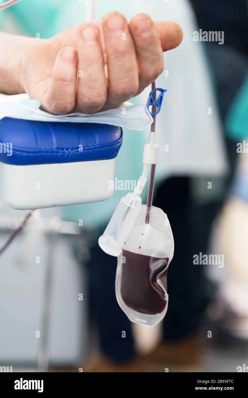 The hand of a man who donates blood. Male donor gives blood in a mobile