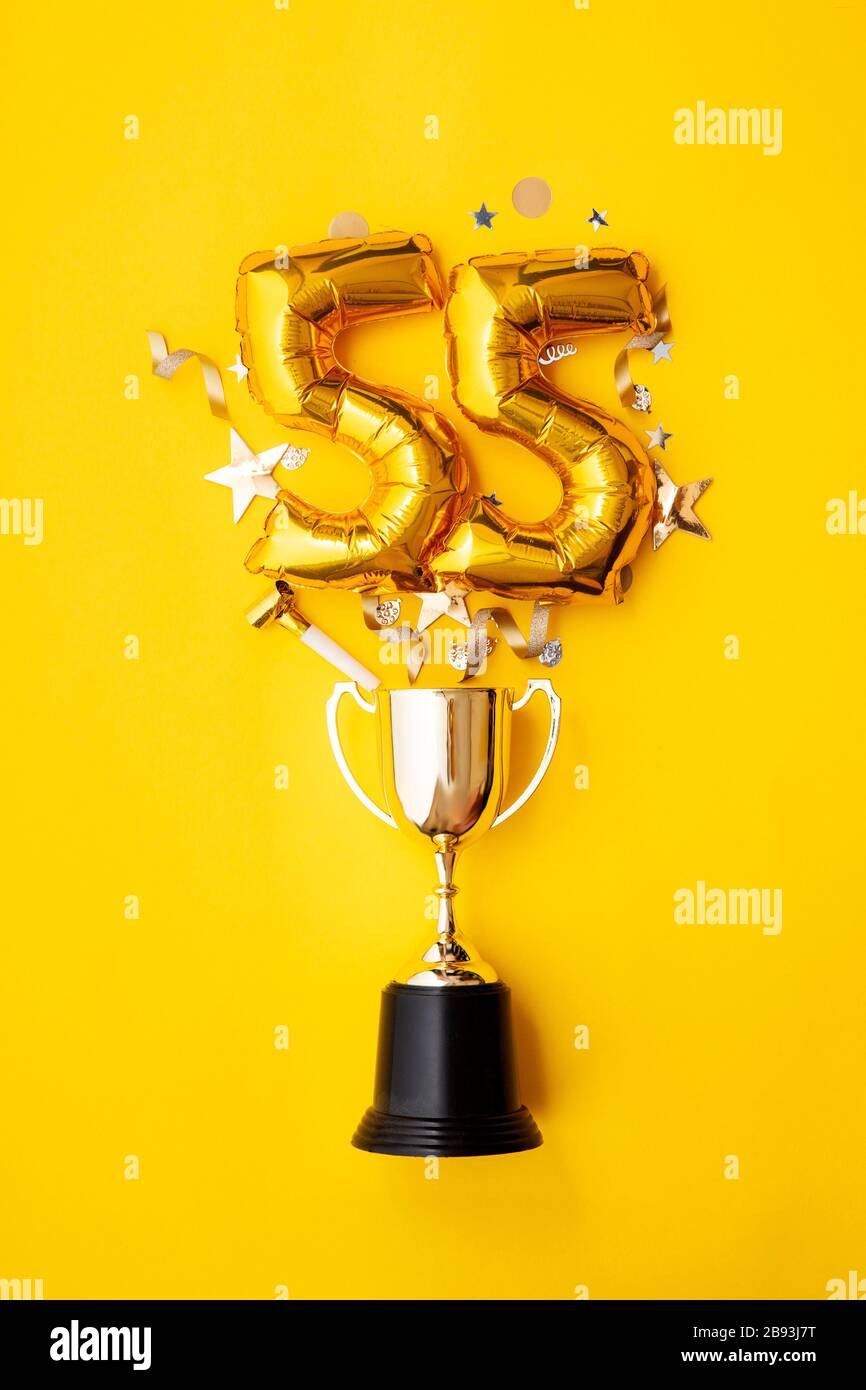 Number 55 gold anniversary celebration balloon exploding from a winning ...