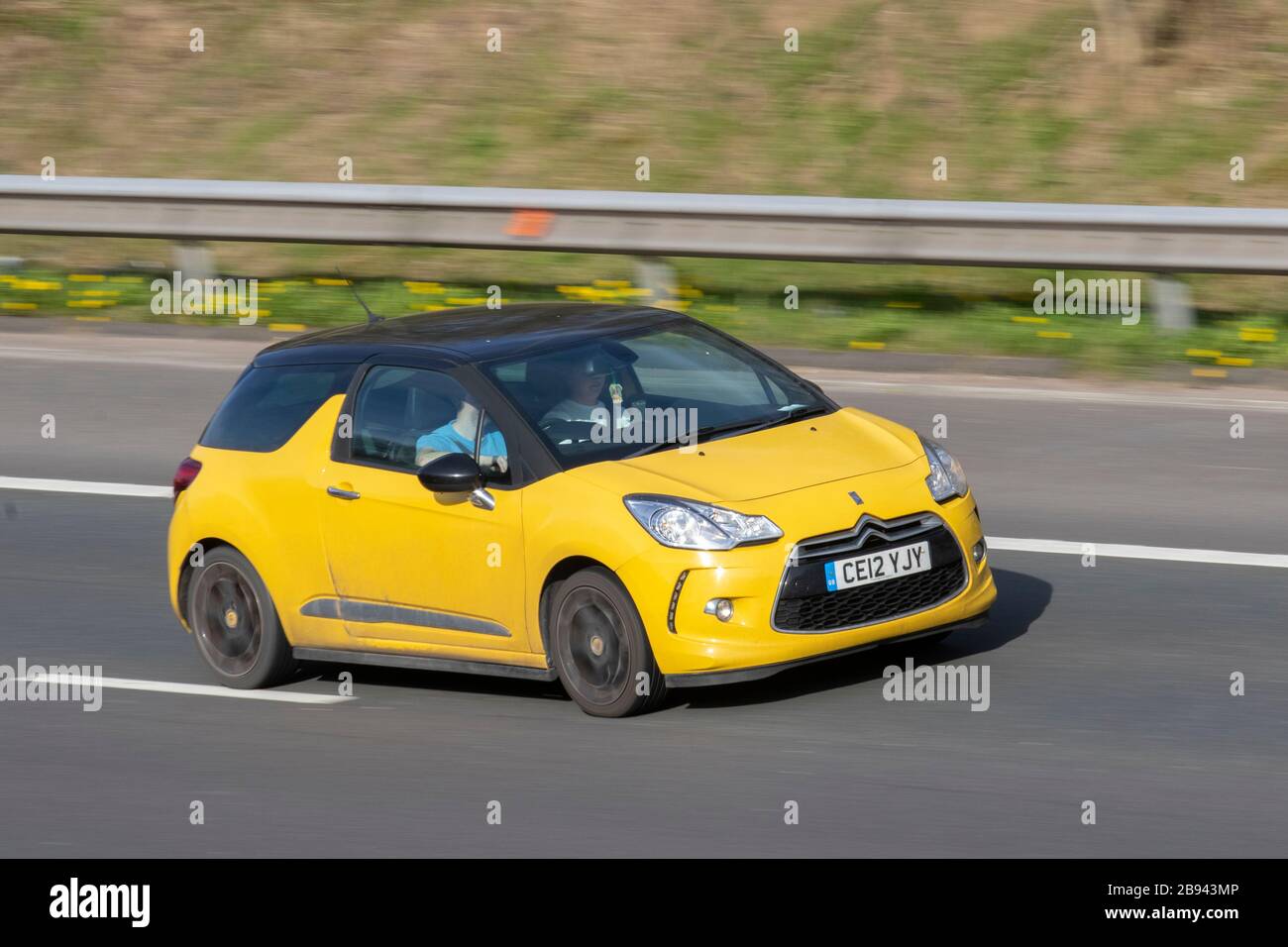 2012 yellow Citroën DS3 Dstyle + E-HDI; UK Vehicular traffic, road transport, modern vehicles, saloon cars, vehicle driving, roads & motors, motoring south-bound on the M61 motorway highway Stock Photo