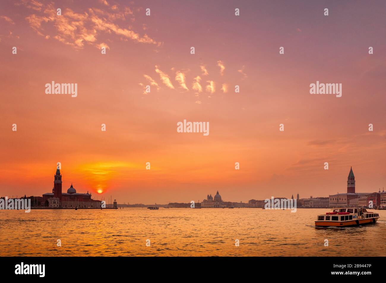 Sunset over Venice, Italy.  Seen is San Giorgio island and the bell tower along with Santa Marie della Salute and St. Mark's Square and the bell tower Stock Photo