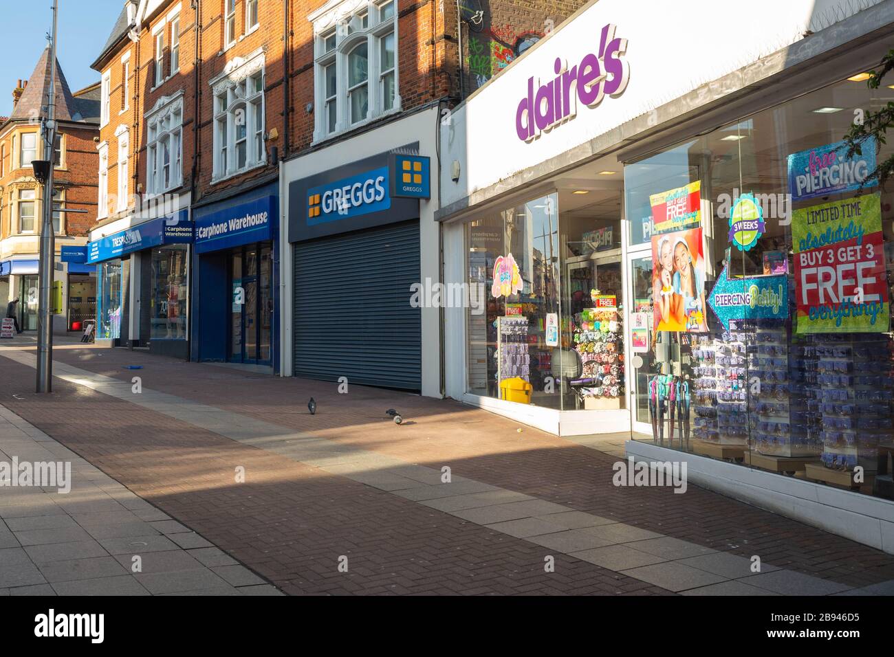Southend-on-Sea, UK. 23rd Mar, 2020. Many shops on the High Street in the Essex town of Southend-on-Sea have already pulled down the shutters and closed for the foreseeable future. Some shops remain open for business as well. Penelope Barritt/Alamy Live News Stock Photo