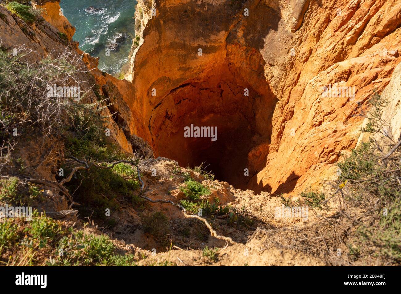 Big hole in a cliff near Ponta da Piedade in Lagos, Portugal Stock Photo