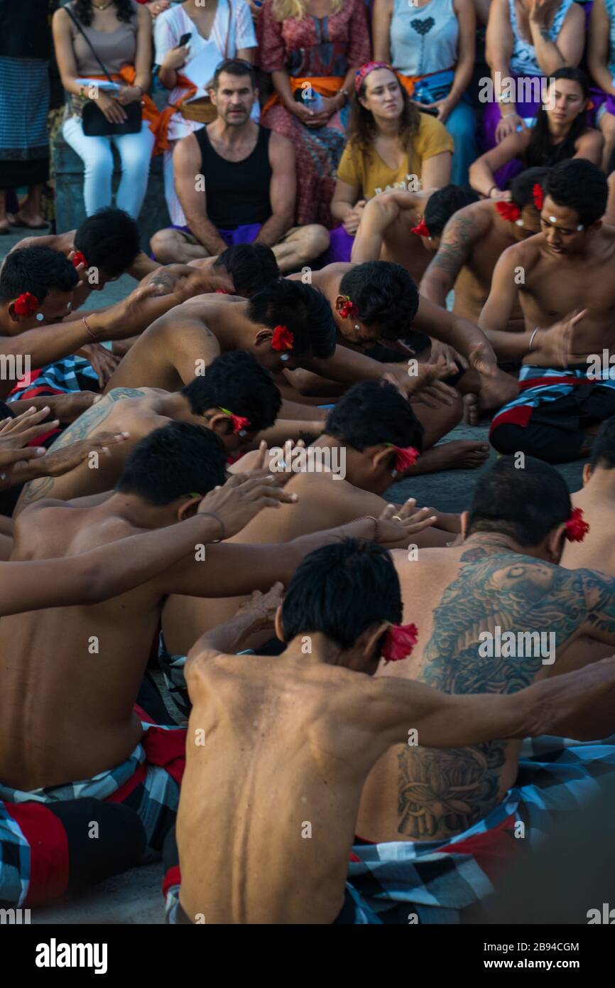 A group of male performers, neatly wrapped in black and white checkered garments at Uluwatu Temple. Stock Photo