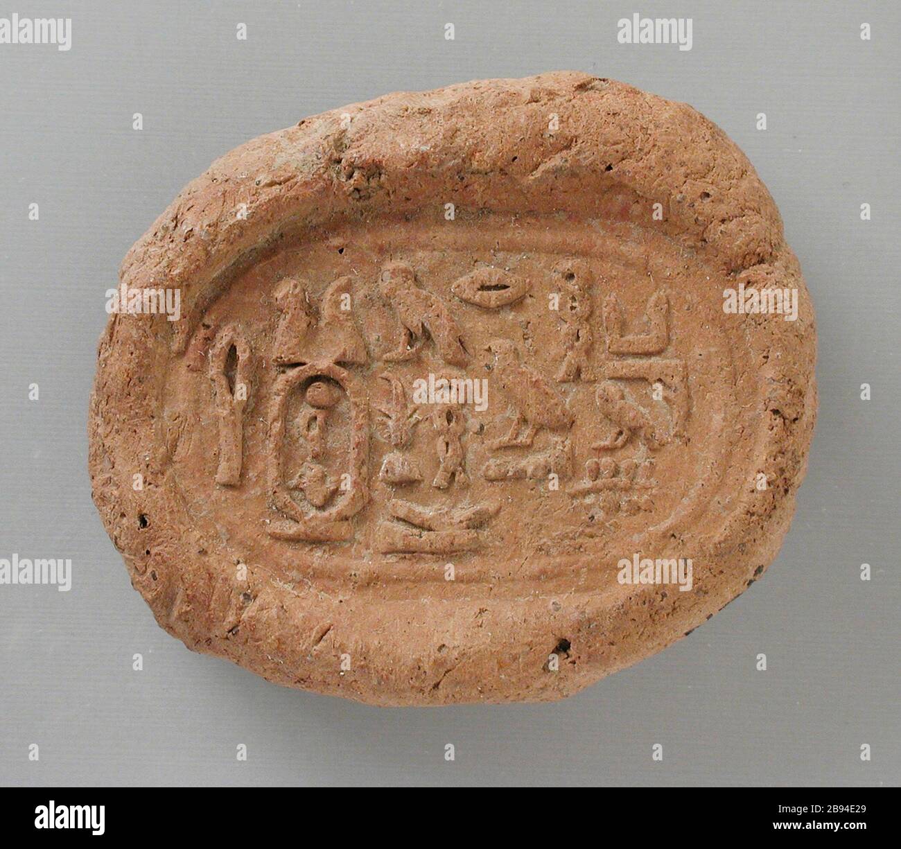 'Seal Impression with Cartouche of Amasis; Tools and Equipment; seal impressions Baked clay Overall:  1 3/8 x 1 5/8 in. (3.49 x 4.13 cm); Imprint: 1 5/16 x  7/8 in. (3.33 x 2.22 cm) Gift of Jerome F. Snyder (M.80.202.305) Egyptian Art; ' Stock Photo