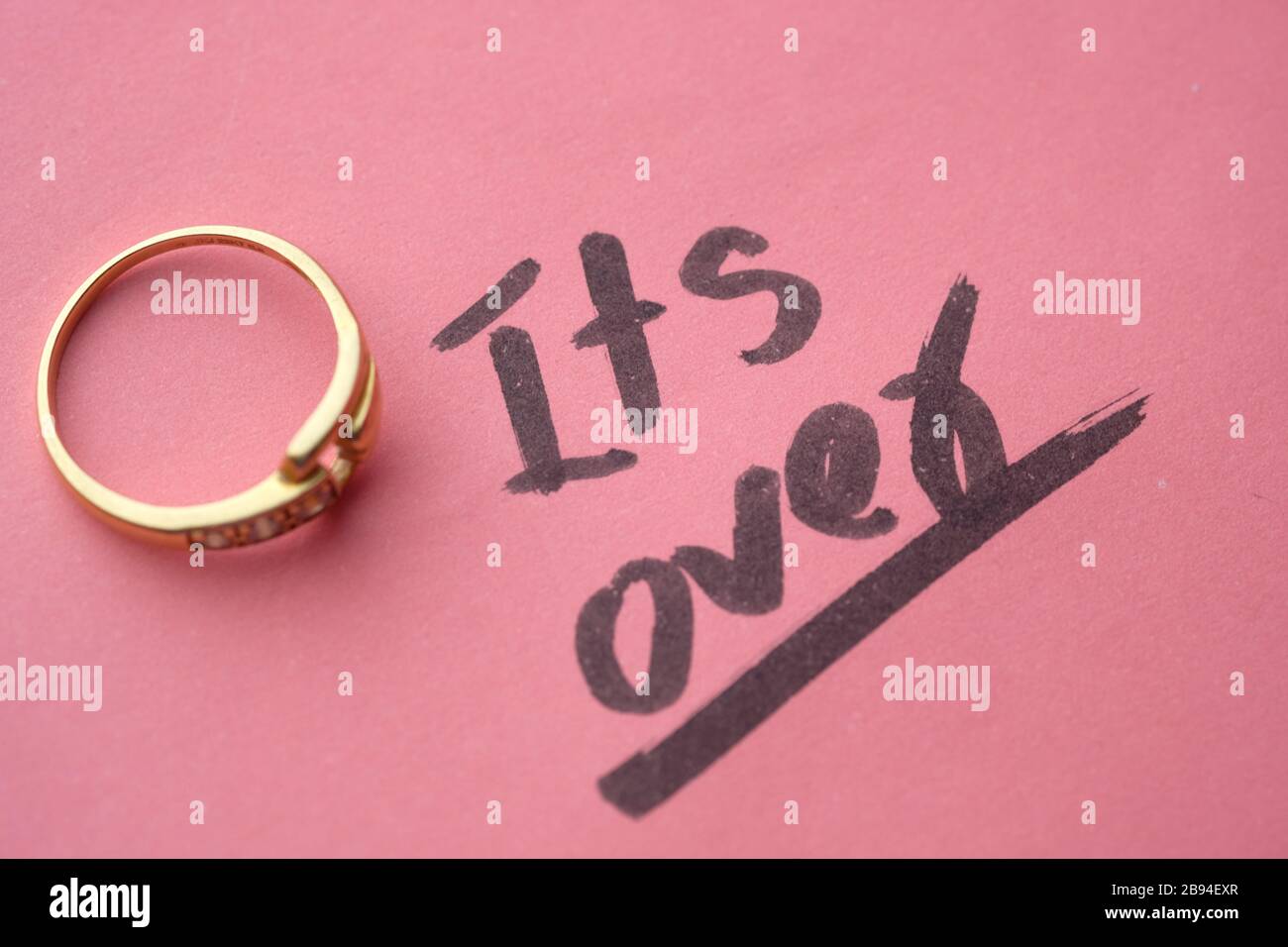Divorce concept with wedding rings on pink background Stock Photo Alamy