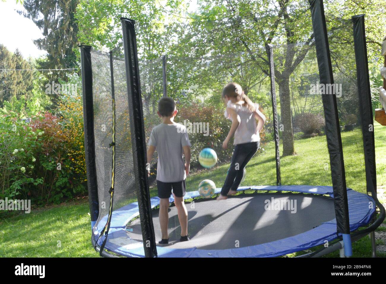 Brother and sister jumping on the trampoline Stock Photo Alamy