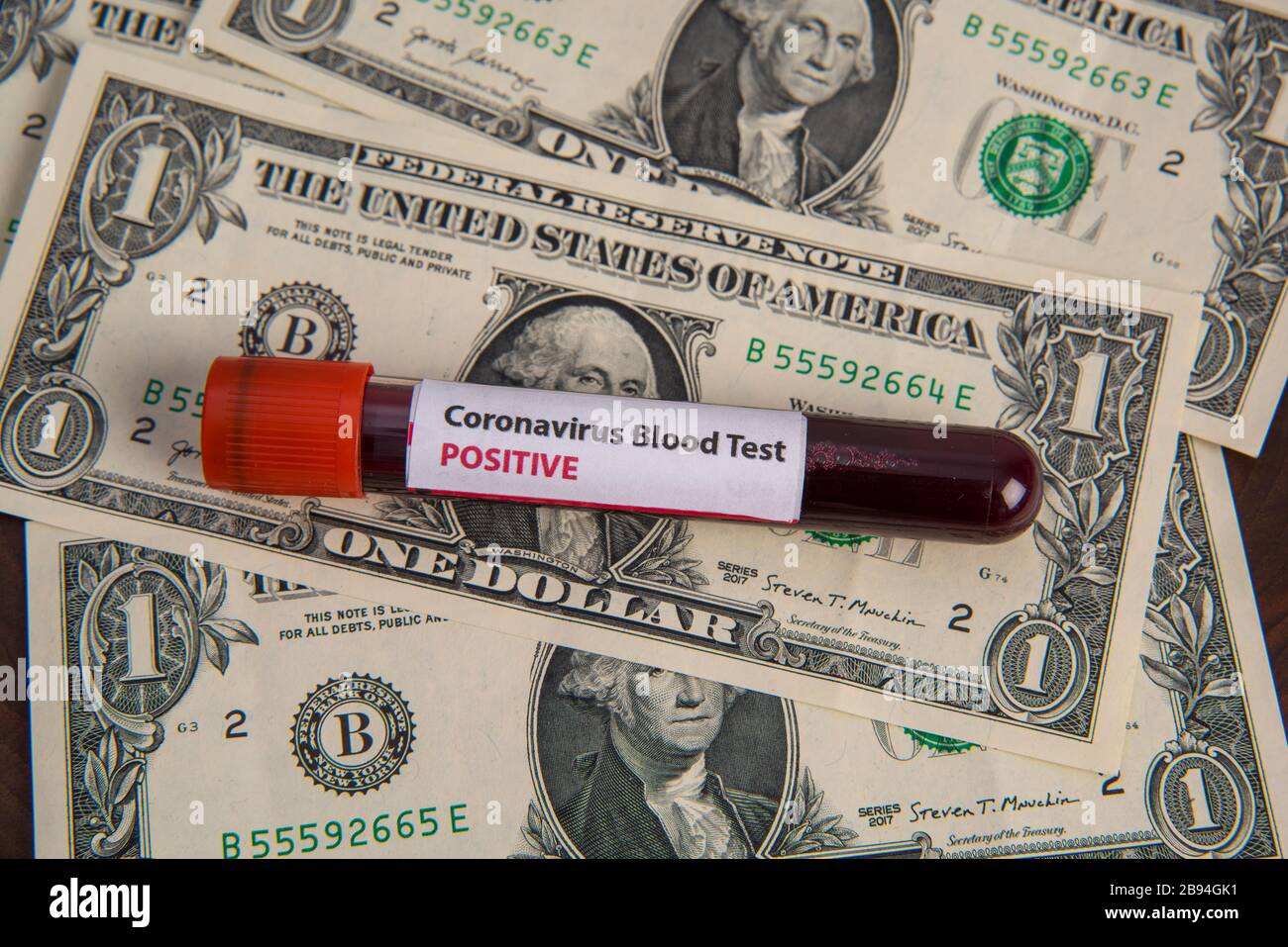 corona virus Covid19 US economic crisis blood tube virus test on dollar banknotes Stock Photo