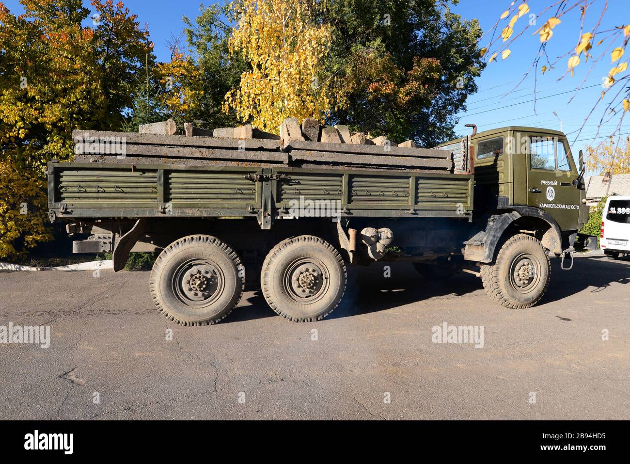 Old truck from the soviet times in Kyrgyzstan. Lateral view of military green lorry in Central Asia. Russian vehicle for heavy cargo transportation. Stock Photo