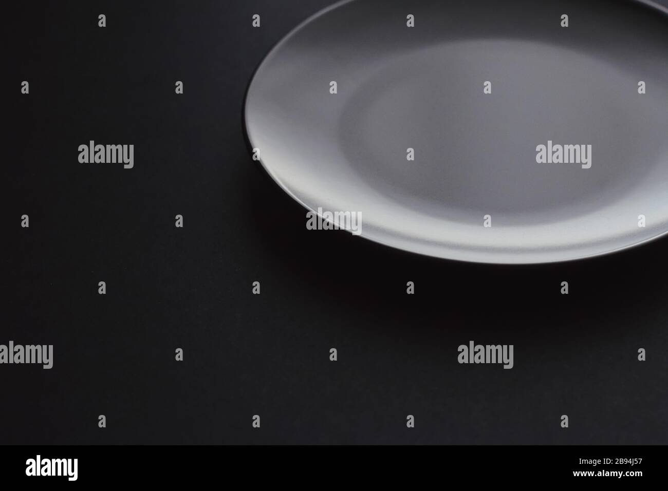 Empty plates on black background, premium dishware for holiday dinner ...