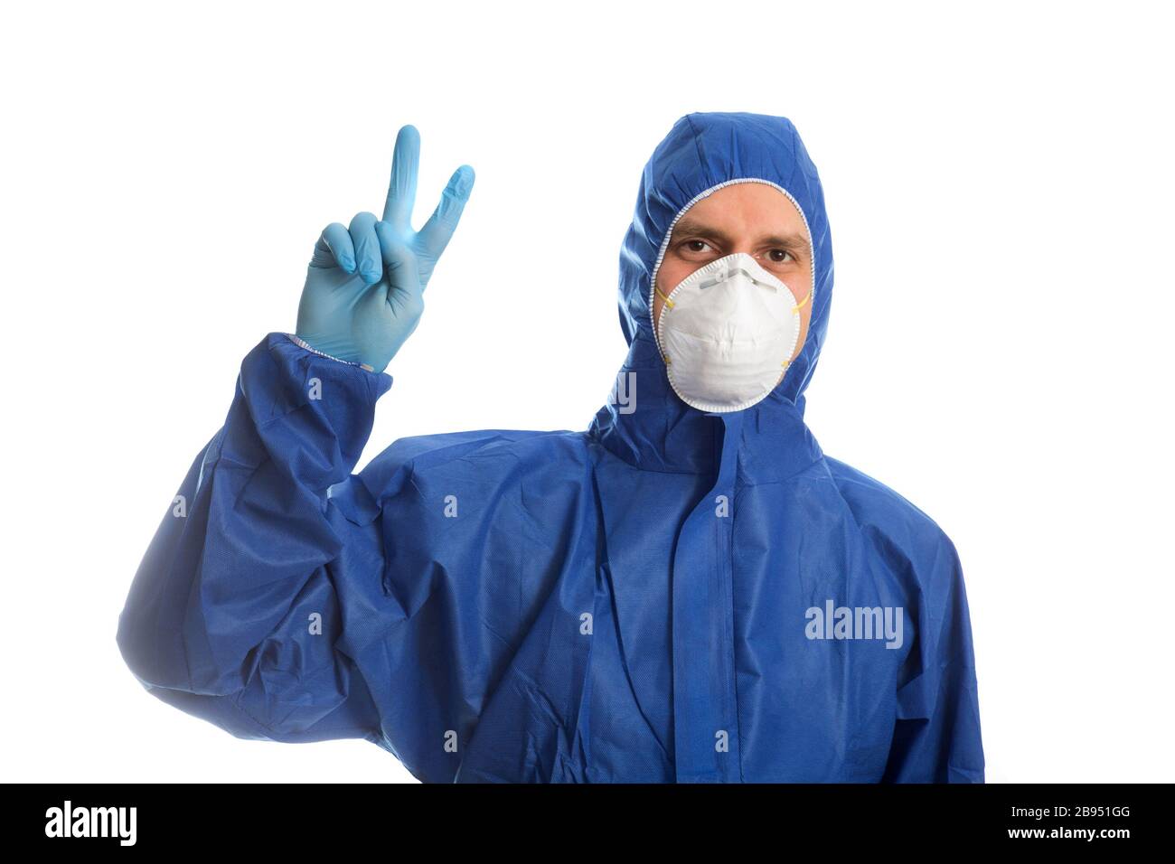 Doctor in protective clothing showing V Stock Photo