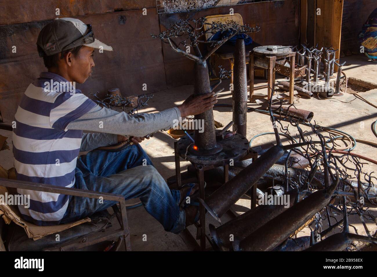 Welder in the social and solidarity enterprise of metalworking with recycled material created by Violette and Dieudonne in Antananarivo Stock Photo