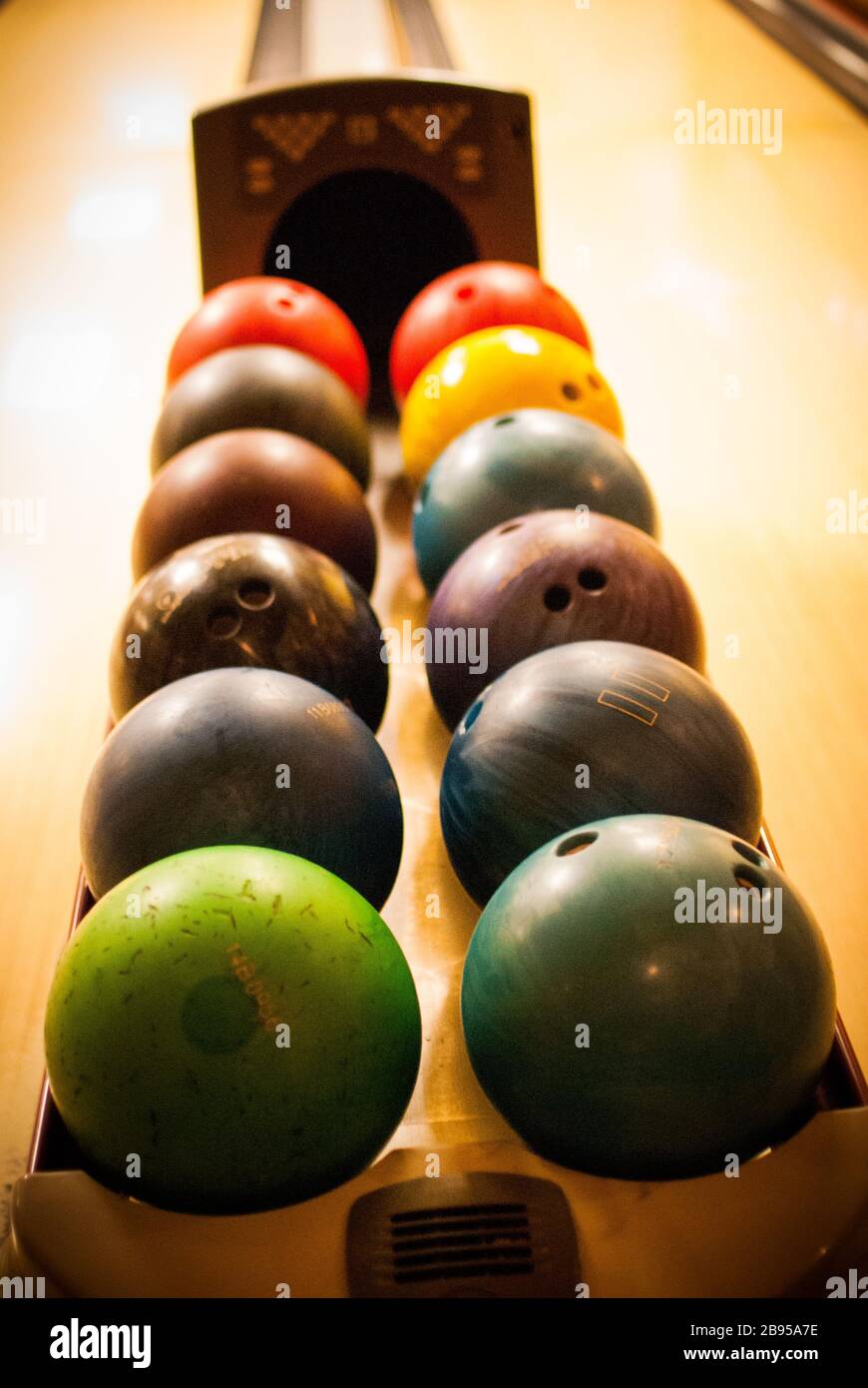 bowling balls lined up ready to be played Stock Photo Alamy