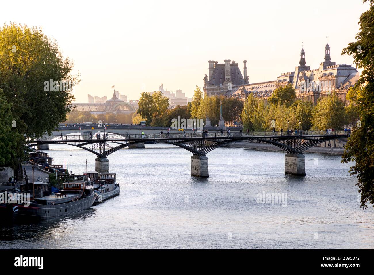 View of River Seine with Pont des Arts, Musee du Louvre and Grand Palais, Paris, Ile-de-France, France Stock Photo