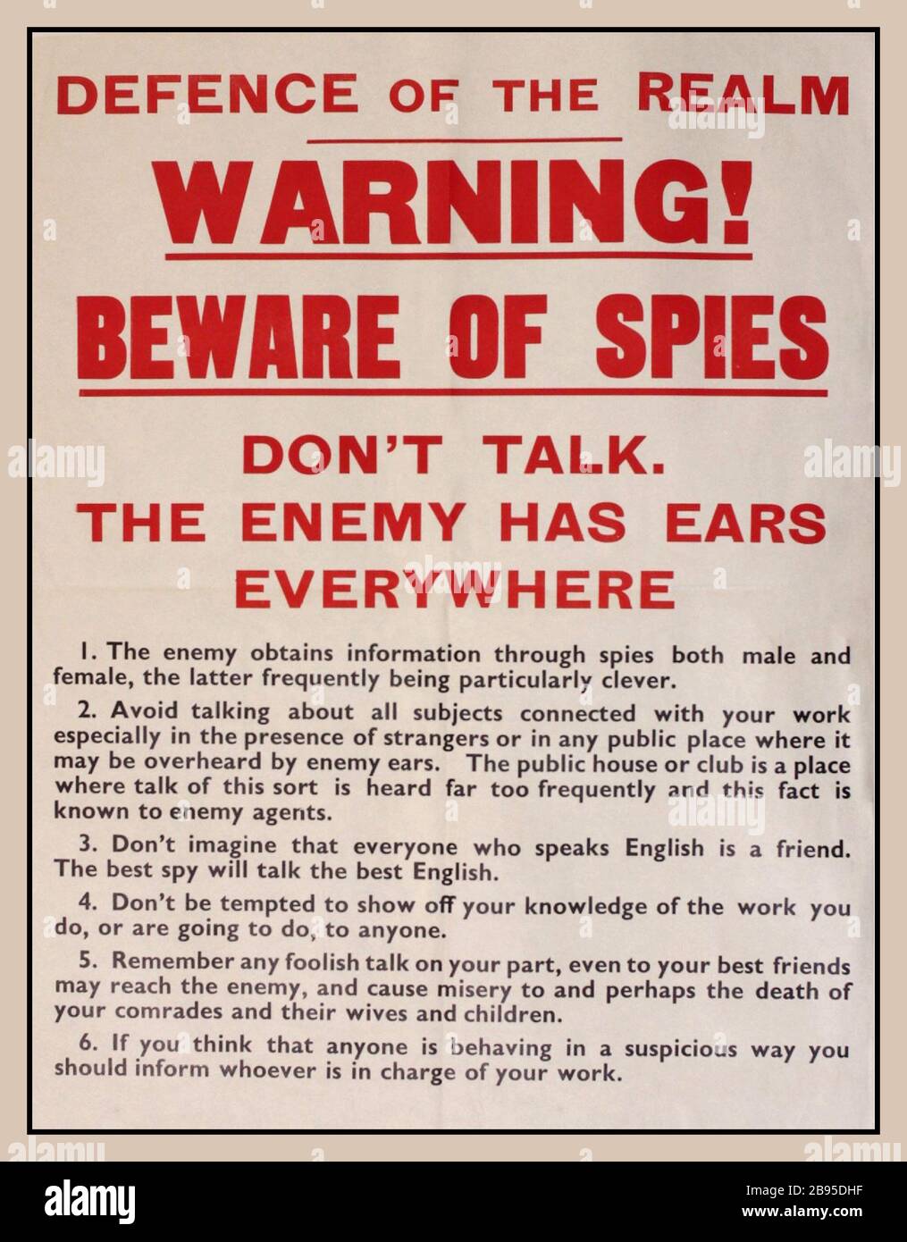 Vintage WW2 Propaganda Information Poster Defence of the Realm,  SPIES SPYING Archive World War II Propaganda Information Poster ‘Warning ! Beware of Spies, Don't Talk The Enemy Has Ears Everywhere,’.  printed by H & S September 1939  World War II public information poster playing on the possible outcomes of careless talk ; and Official Secrets Acts, 1911 Stock Photo