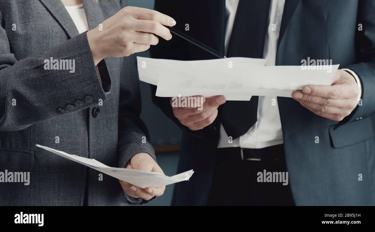 Midsection of businesspeople discussing issues Stock Photo