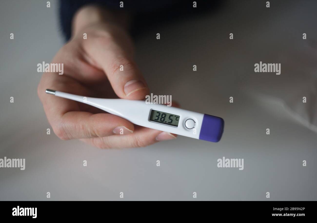 https://c8.alamy.com/comp/2B95N2P/man-holding-thermometer-with-385-degrees-high-temperature-close-up-2B95N2P.jpg