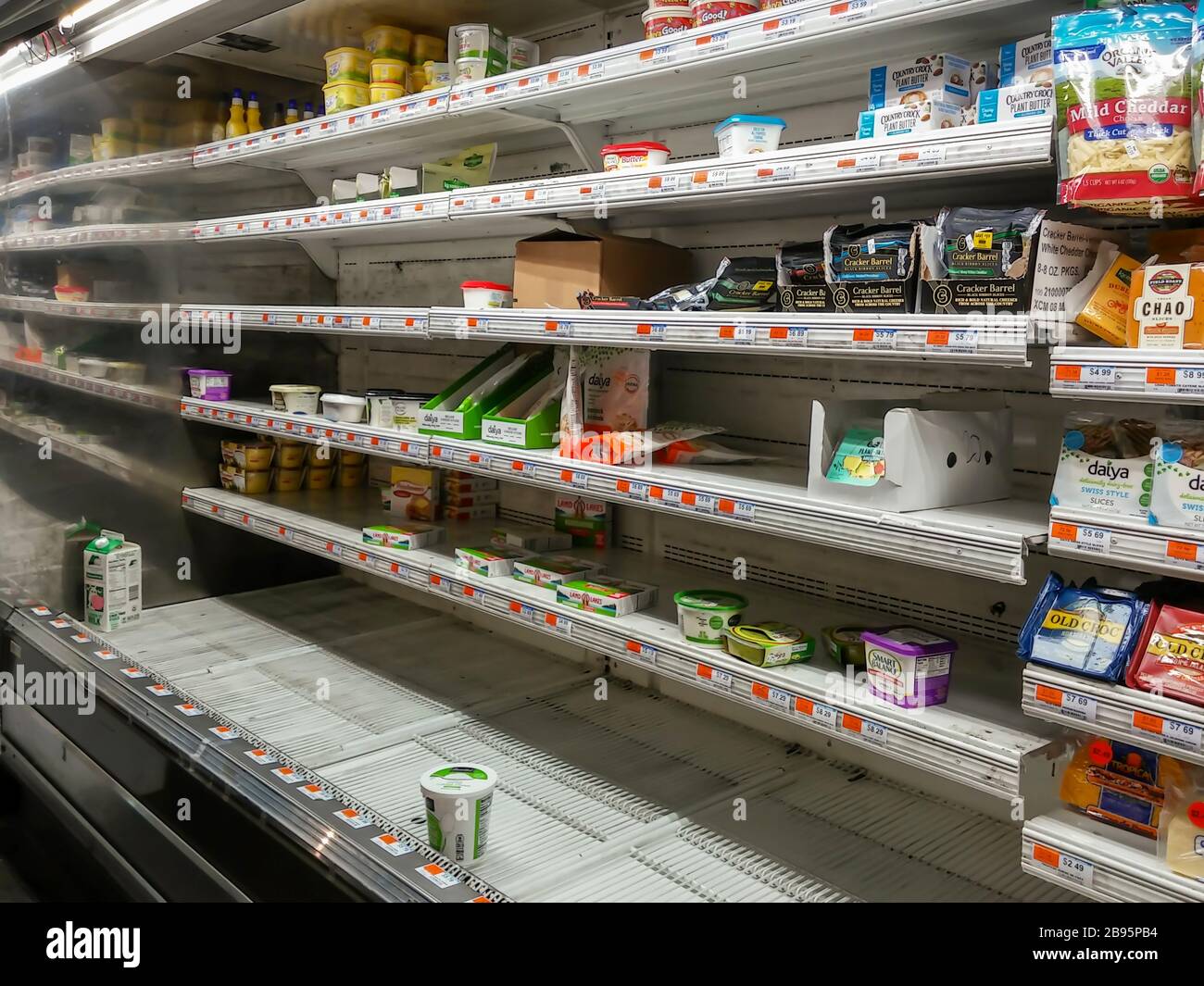 Empty dairy shelves awaiting restocking in a supermarket in New York