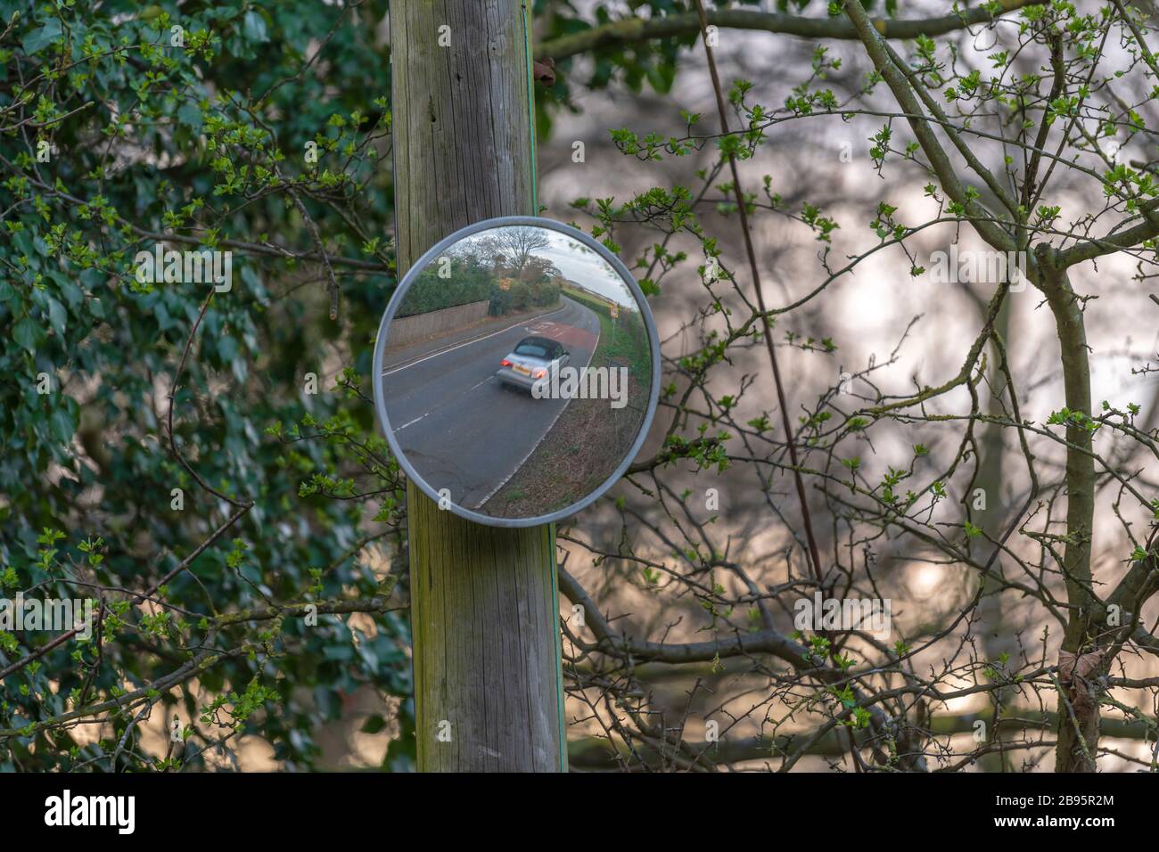 Blind spot convex mirror on a post in Aspley Guise, Milton Keyns Stock Photo