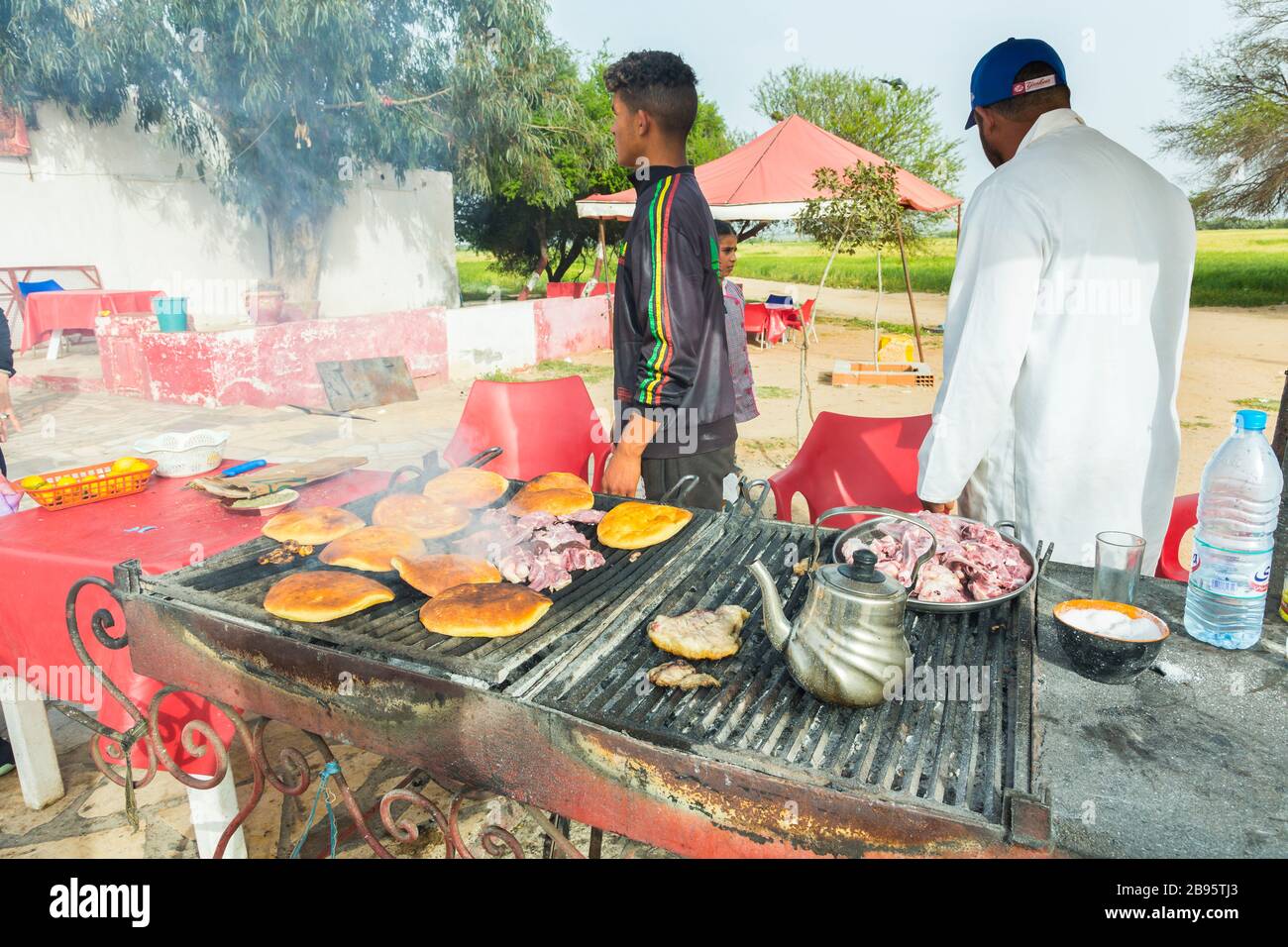 Cooking lamb in a road food stall. Stock Photo