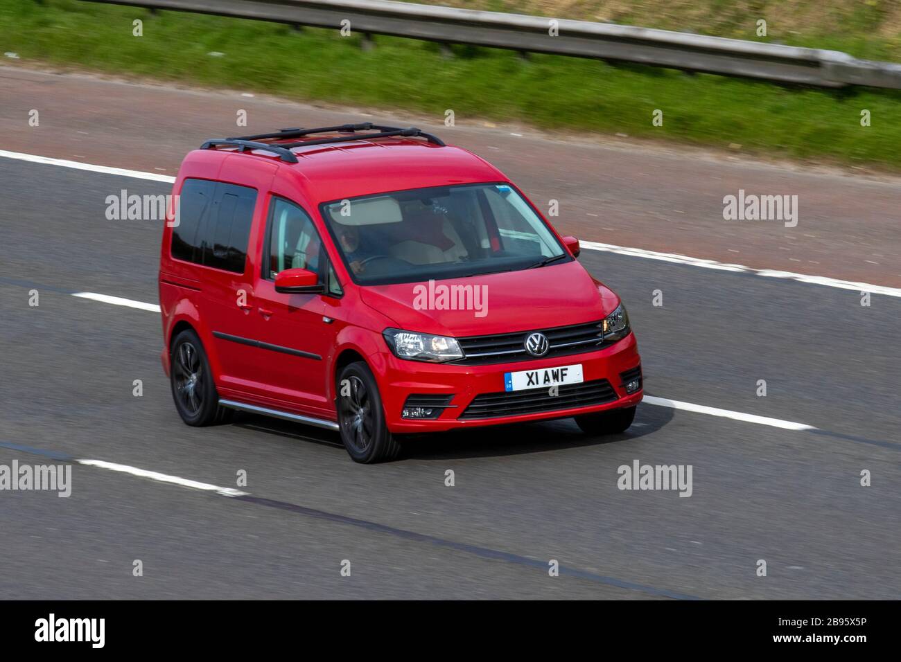 Volkswagen Caddy 2K first facelift in the motion on highway road. Compact  panel van at the city street Stock Photo