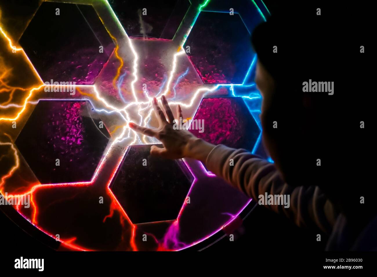 Woman using interactive touchscreen exposition in science museum. Stock Photo