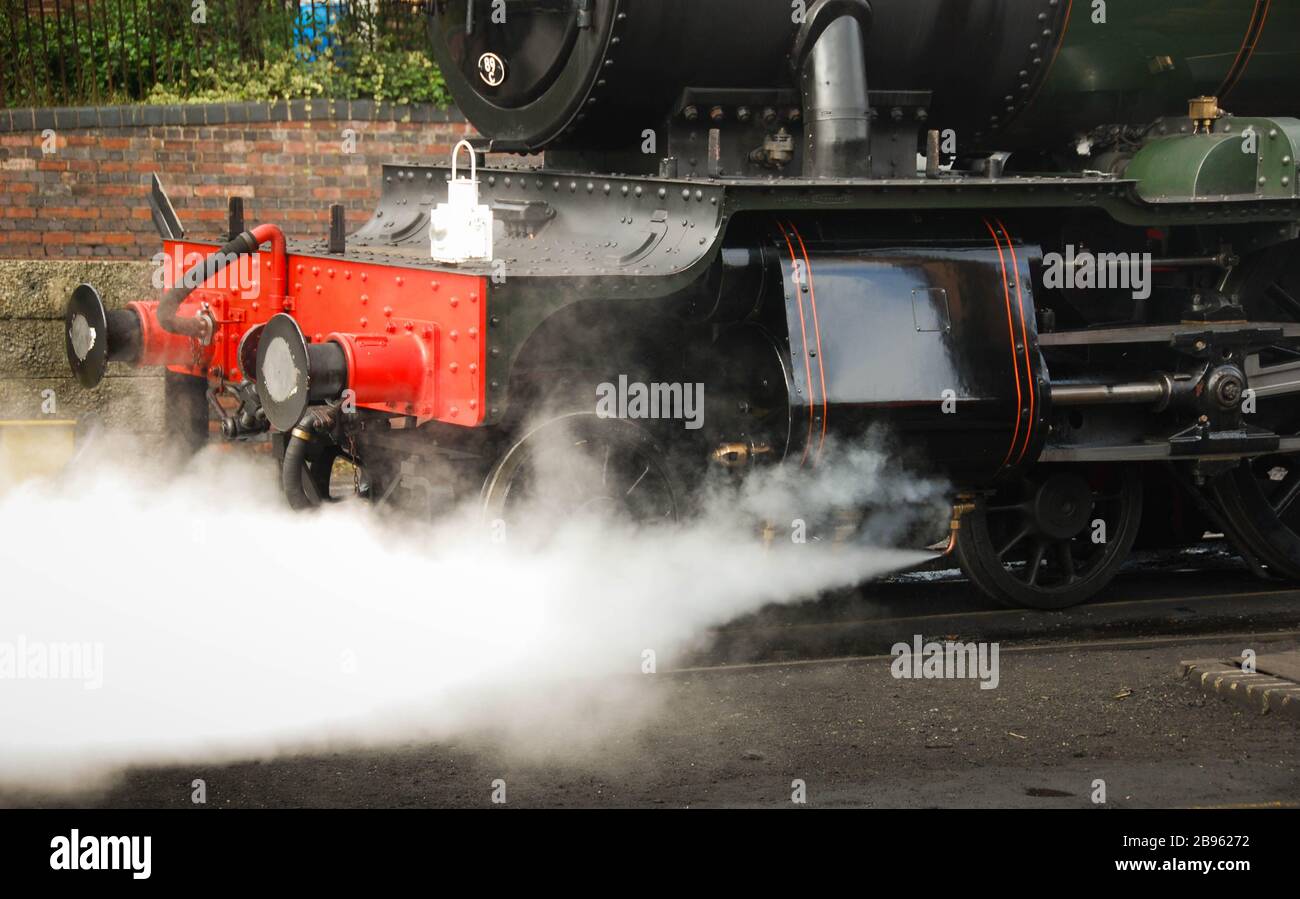 Bridgenorth, England - August 2016: Close up of steam shooting out of the piston of a steam locomotive Stock Photo