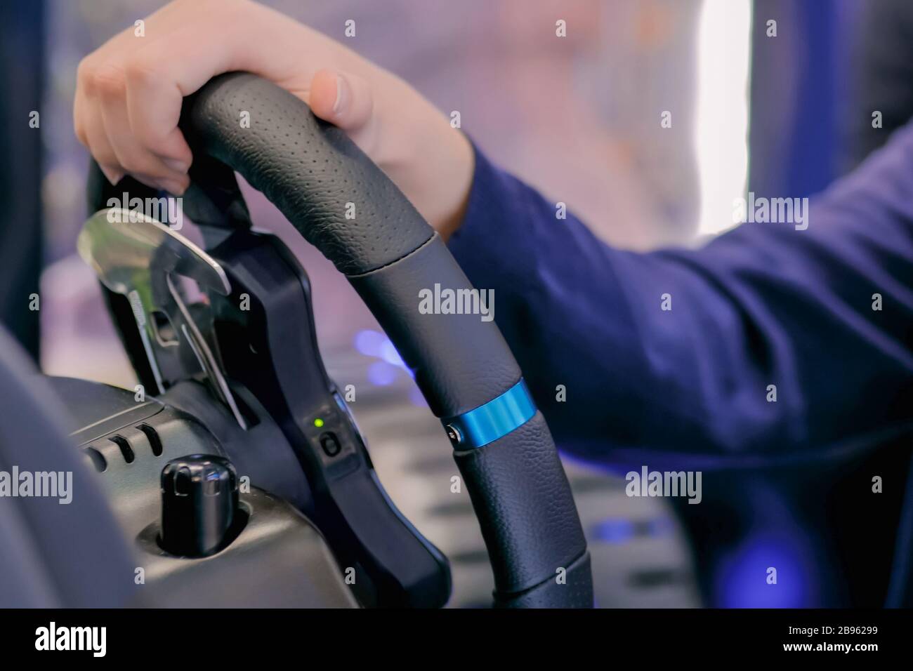 Man using gaming steering wheel joystick at technology exhibition Stock Photo