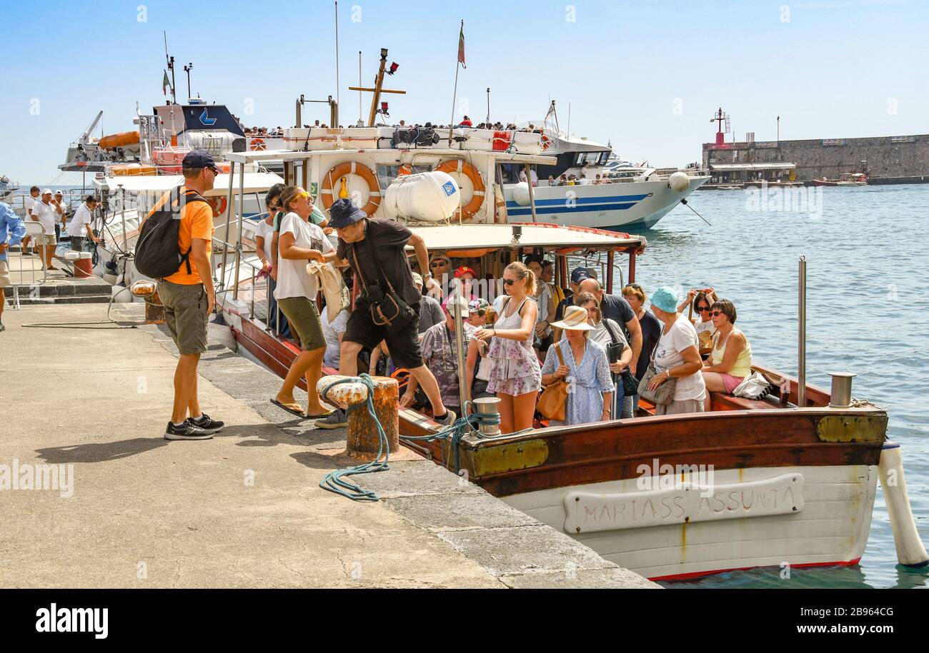 AMALFI, ITALY - AUGUST 2019: People getting off a small motor boat after a cruise along Italy's Amalfi coast Stock Photo