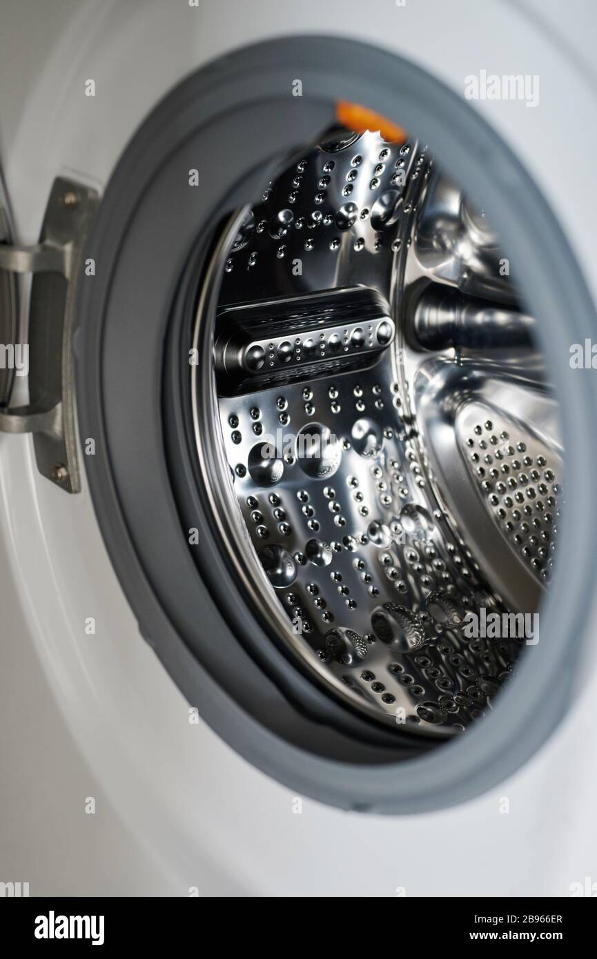 Clean open washing machine loader with shiny metal tube Stock Photo - Alamy