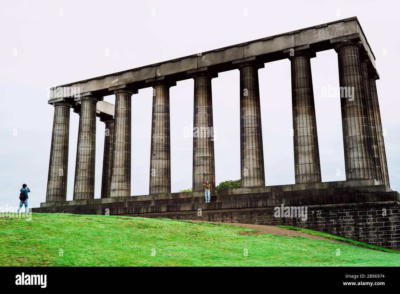 Tourists take pictures at National Monument of Scotland in Edinburgh. Stock Photo