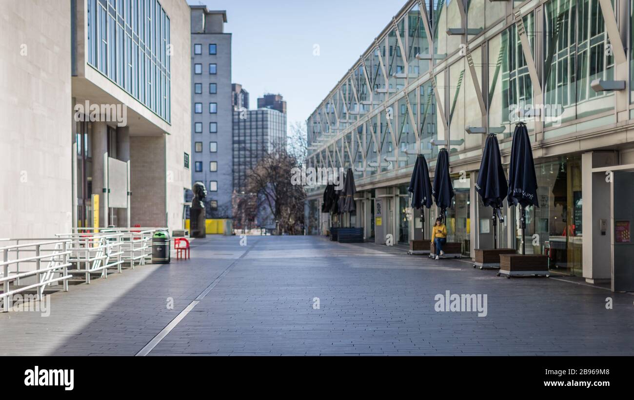 London, England, UK - March 23, 2020: A lone worker on the Southbank in a deserted London under lockdown during the Corona Virus Covid-19 outbreak. Stock Photo